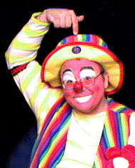 Raynbow the Clown points to his head