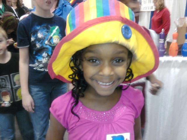 A young lady models Raynbow's hat