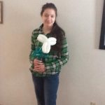 Young lady holding balloon flower