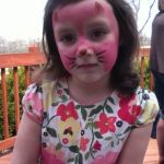 Young girl who wanted her face painted as a pink kitten