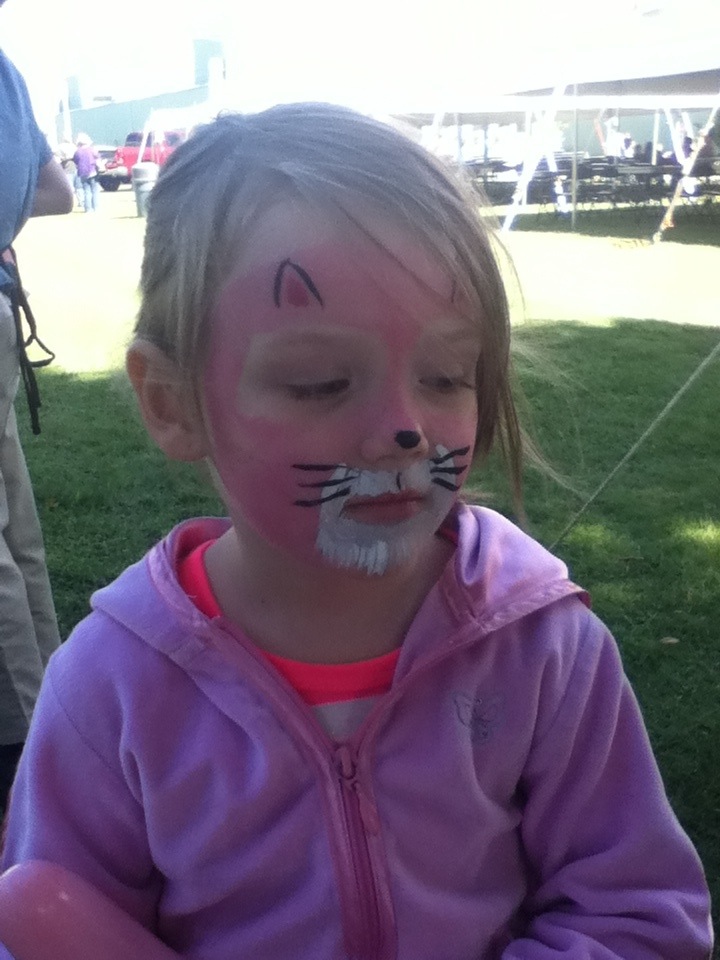 Young girl with a painted cat's face