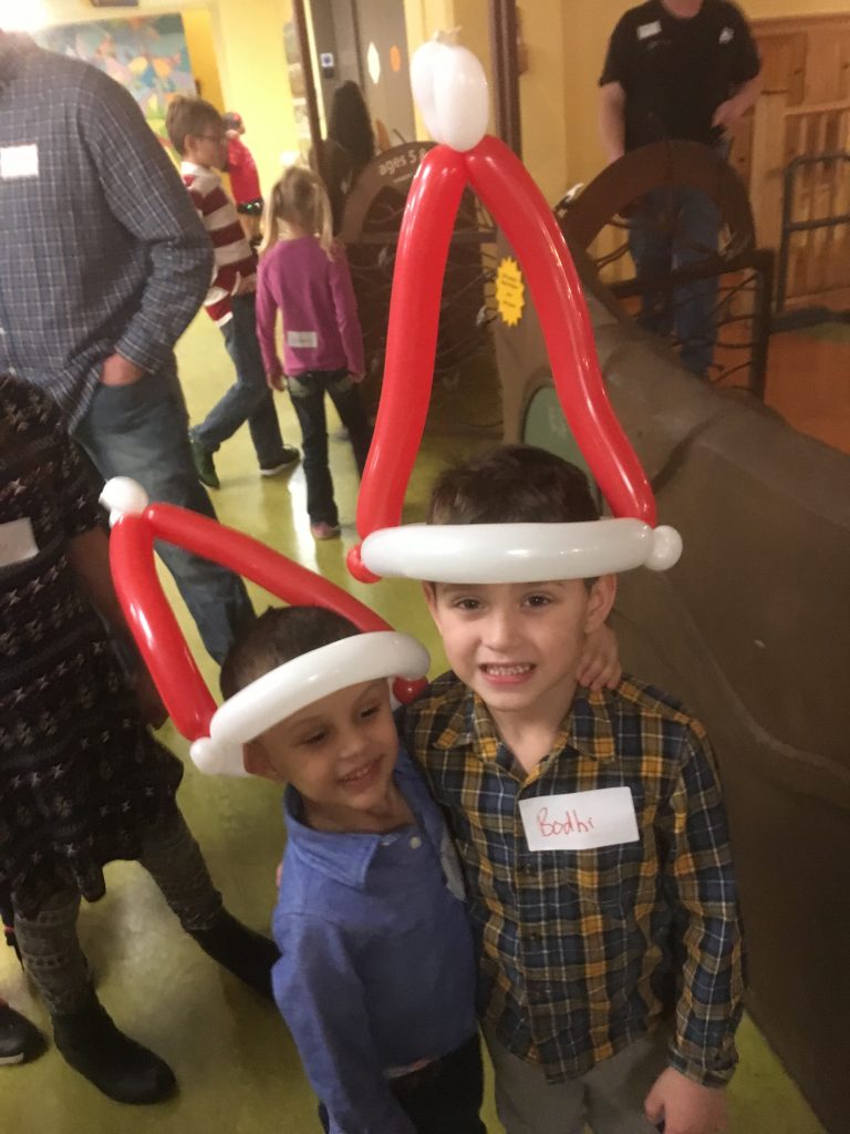 Two brothers in Santa hats hugging