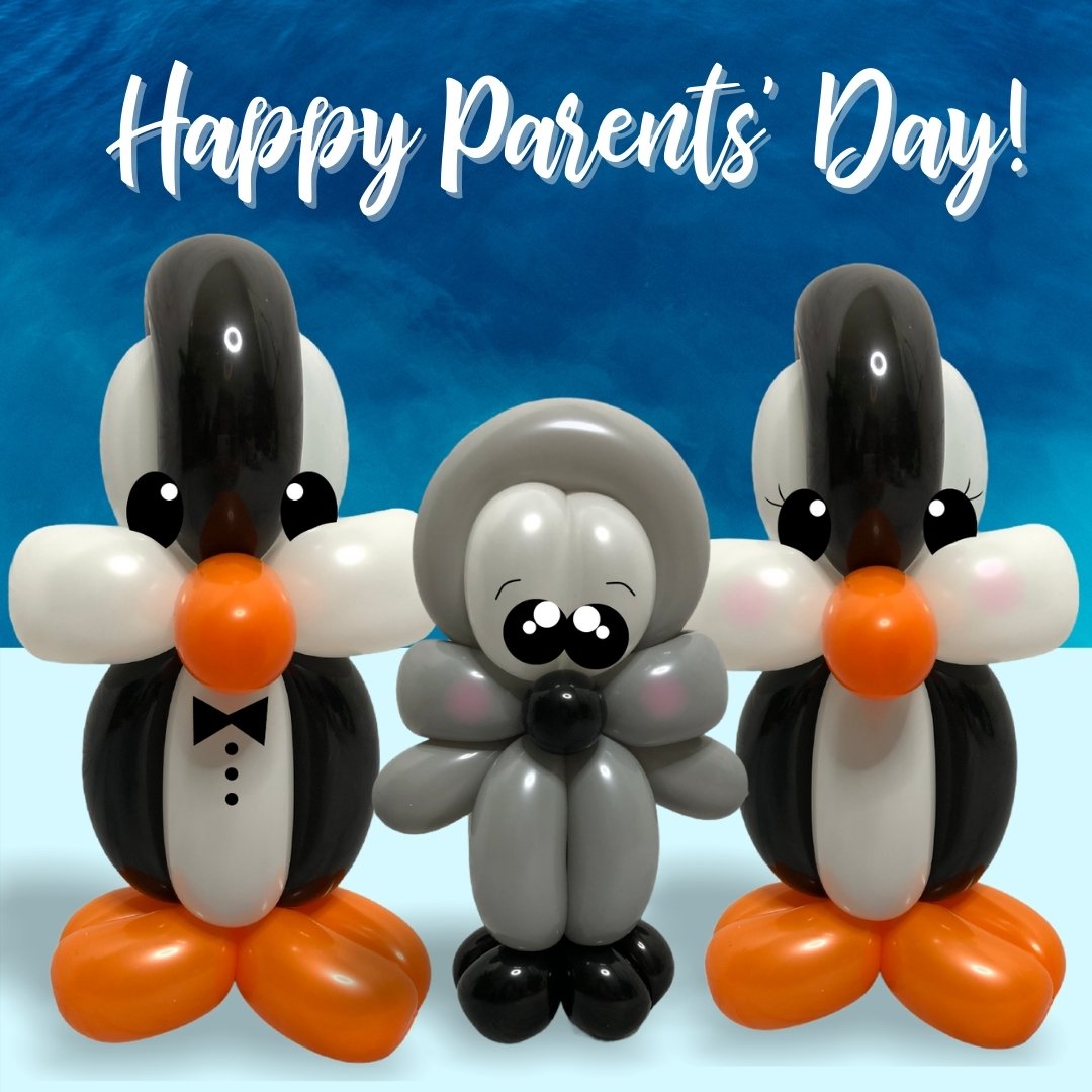 Happy Parents Day - parent penguins with their baby