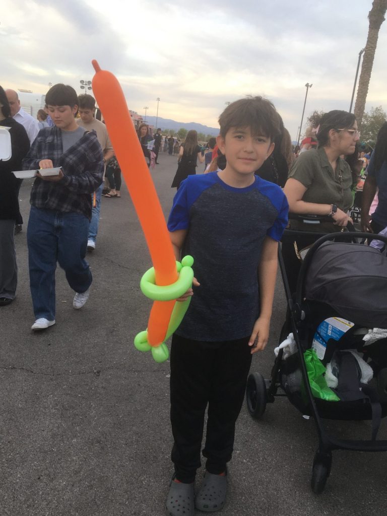 Young man with a carrot sword at the Easter at Central event on Saturday