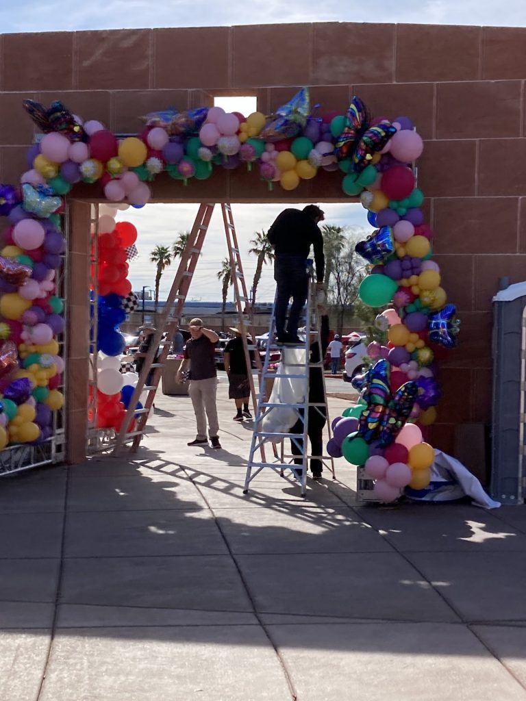 UMC Spring Wellness Event - setting up the balloon arch